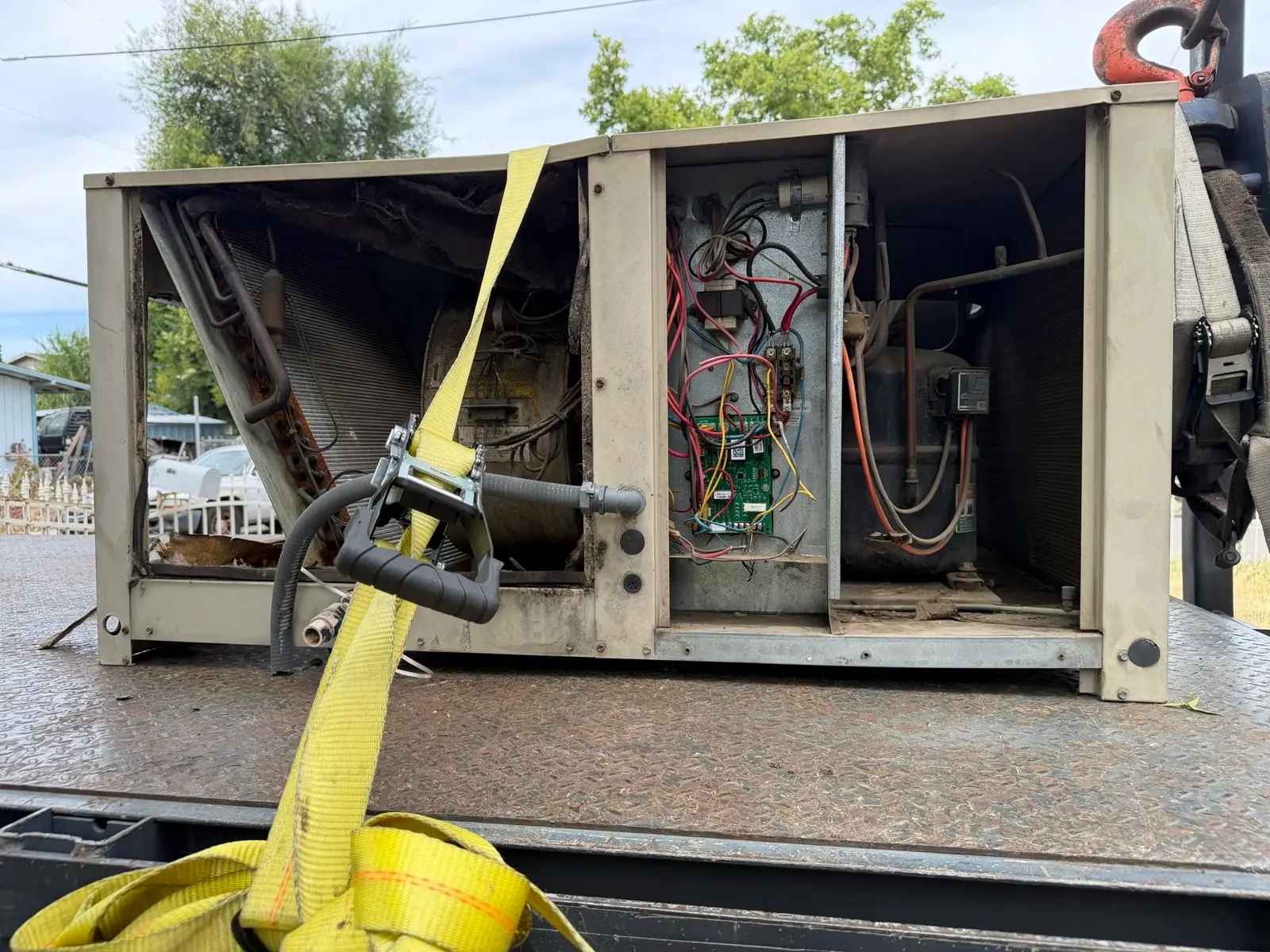 Old failed condensing unit removed and loaded for haul-away