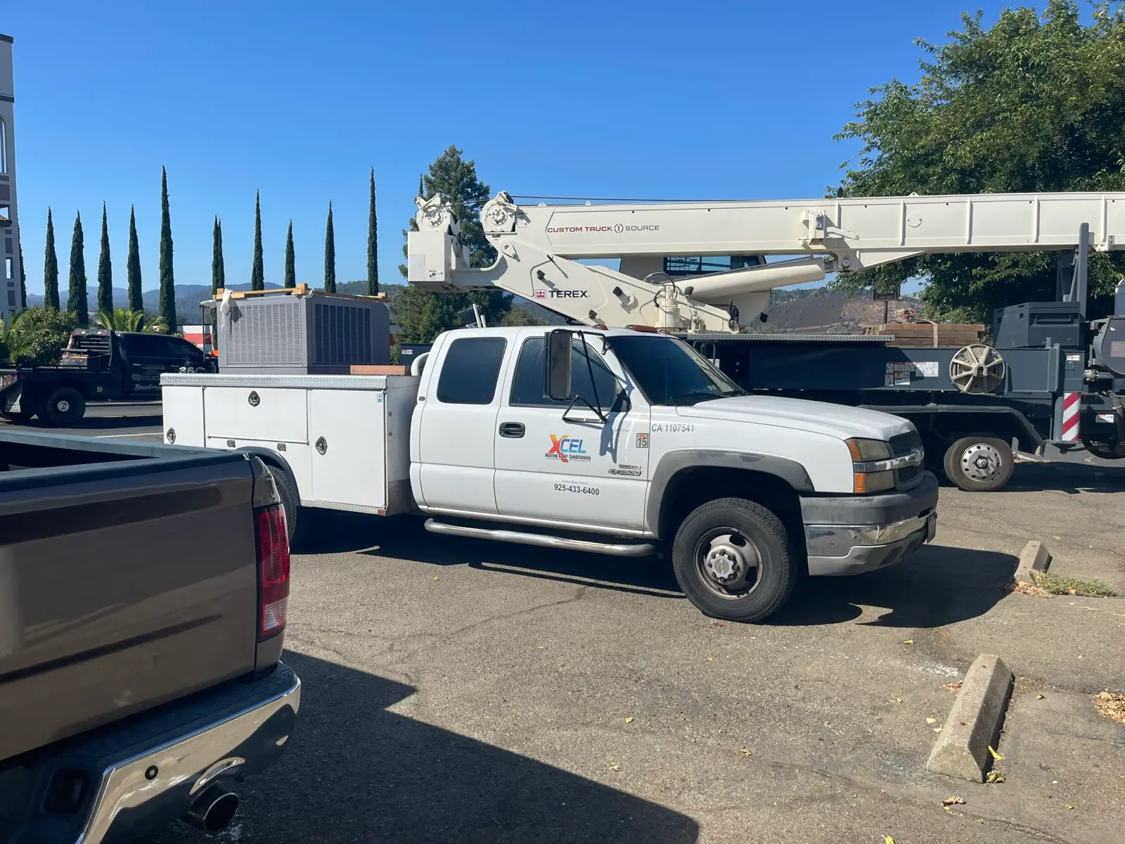 XCEL service truck loaded with a new HVAC package unit ready for install