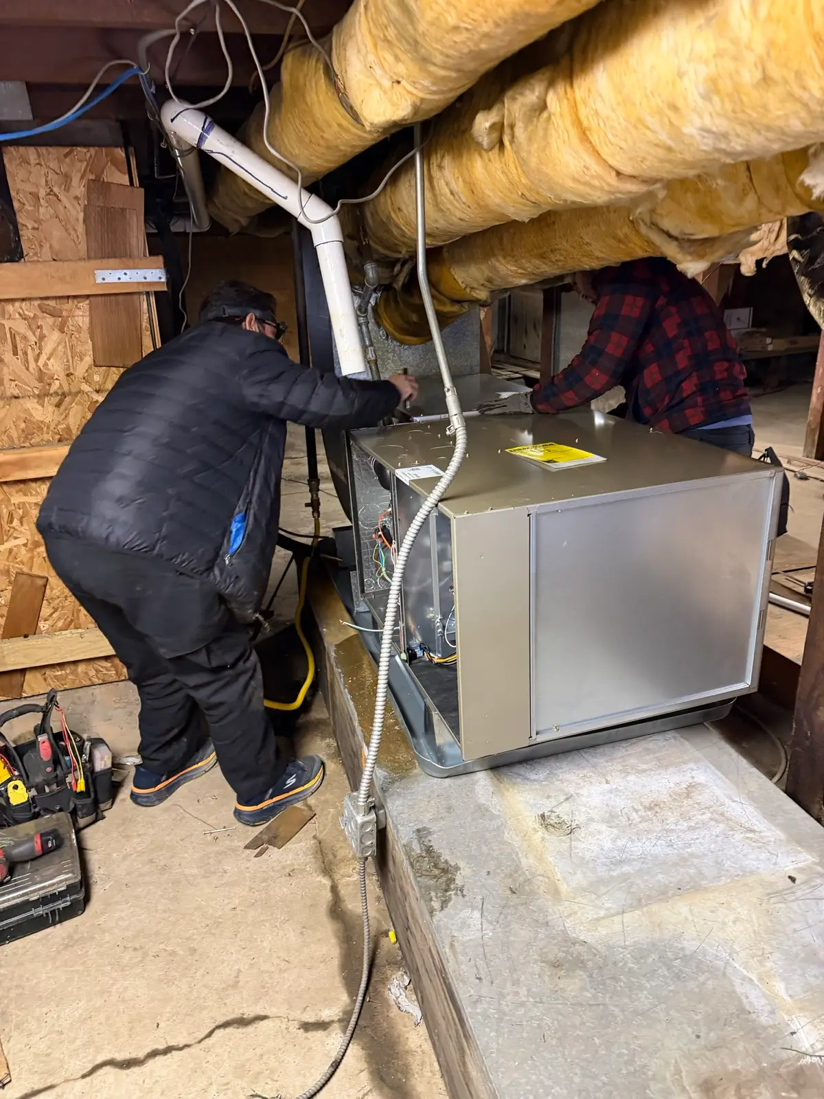XCEL technicians installing a high-efficiency furnace in a Contra Costa County home