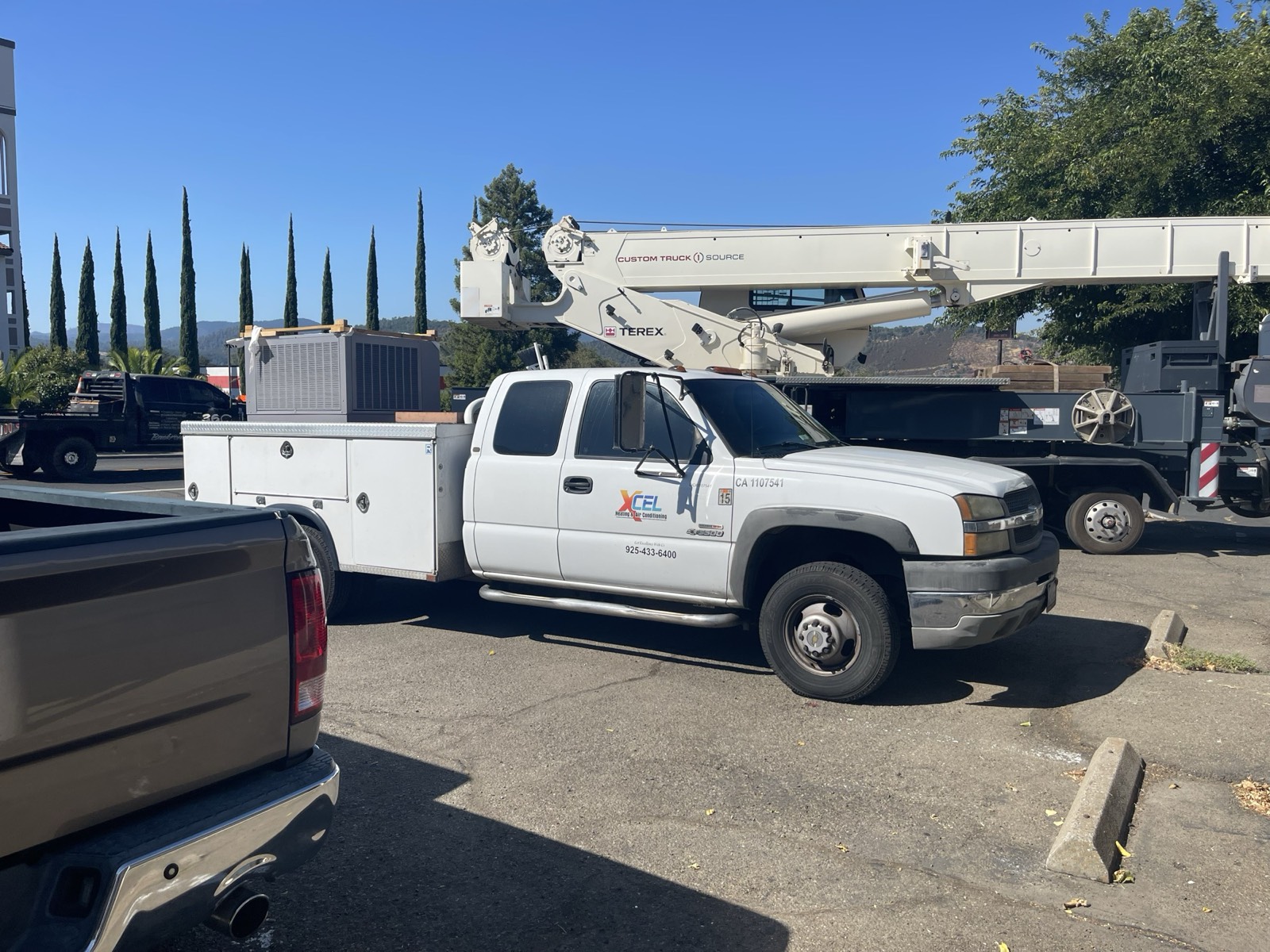 XCEL service truck loaded with a new HVAC package unit ready for install