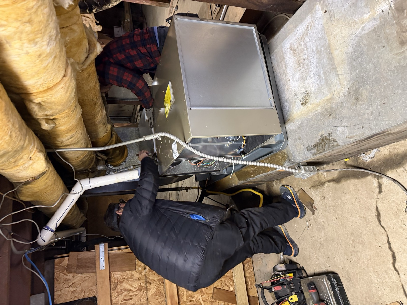 XCEL technicians installing a high-efficiency furnace in a Contra Costa County home