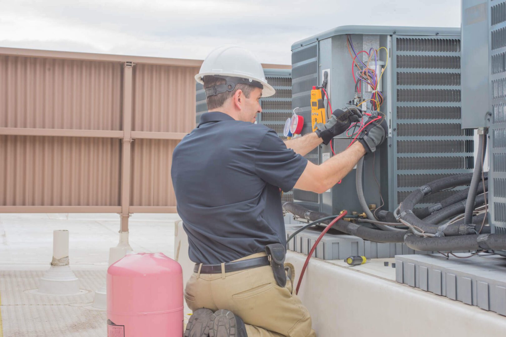 Technician checking HVAC due to air conditioner noise x jpeg